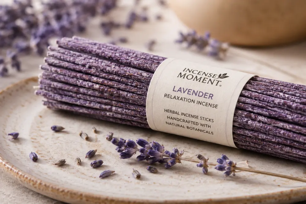 Natural herbal incense stick burning on wooden holder beside bed at night